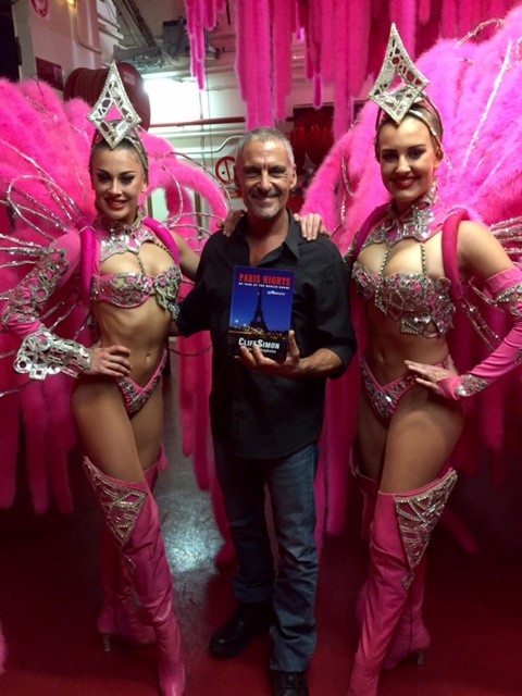 Cliff – the returning hero -- with memoir in hand flanked by two beautiful dance girls at the Moulin Rouge, 2016.
